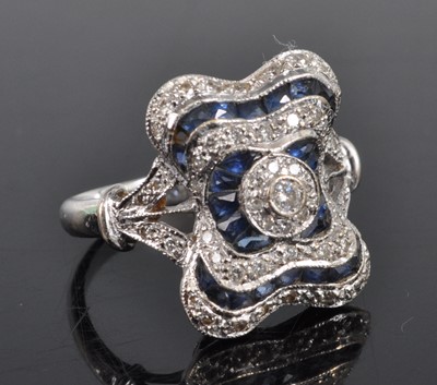 Lot 1187 - A white metal, sapphire and diamond cushion...
