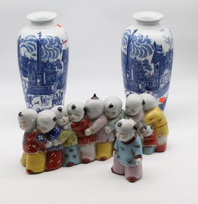 Lot 21 - A pair of blue & white vases of baluster form...