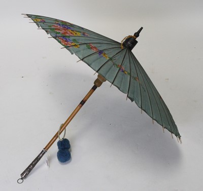 Lot 106 - A 20th century parasol having bamboo shaft...