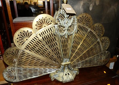 Lot 1410 - A brass peacock spark guard