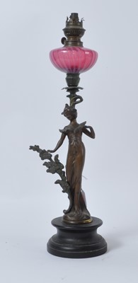 Lot 56 - A late 19th century figural spelter oil lamp,...
