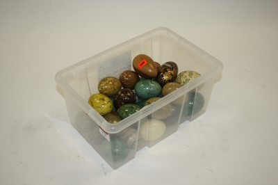 Lot 174 - A box of polished hardstone, treen, and papier-...