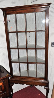 Lot 1153 - A joined oak freestanding single door glazed...