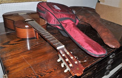 Lot 1158 - Three various guitars, two with carry bags