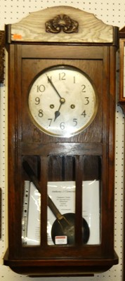 Lot 1161 - A 1930s oak drop trunk wall clock, with...