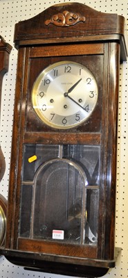 Lot 1168 - A 1930s beech drop trunk wall clock, having...