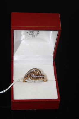 Lot 414 - A contemporary 9ct gold diamond dress ring,...