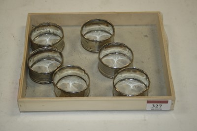 Lot 327 - A set of six white metal napkin rings, each...