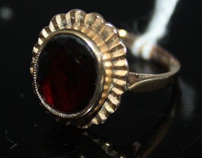 Lot 418 - A 9ct gold and almandine garnet set dress ring,...