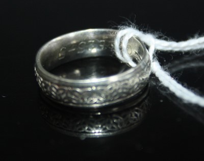 Lot 420 - A 9ct white gold Celtic knot decorated wedding...