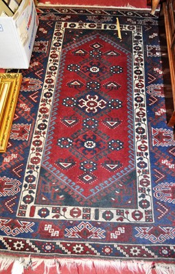 Lot 1198 - A Persian woollen Shiraz red ground rug, 185 x...