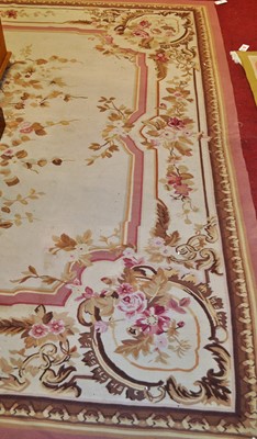 Lot 1201 - A large machine-made cream ground floral...