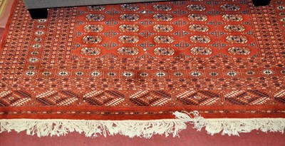 Lot 1202 - A Persian style red ground woollen Bokhara rug,...