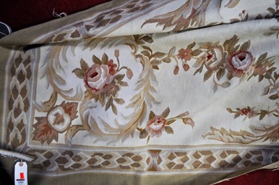 Lot 1204 - A machine-woven cream ground floral decorated...