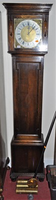 Lot 1214 - A 1930s oak longcase clock, the silvered and...