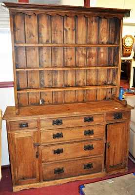 Lot 1195 - A rustic pine kitchen dresser, having...