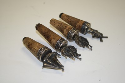 Lot 345 - A set of four white metal bottle stoppers,...