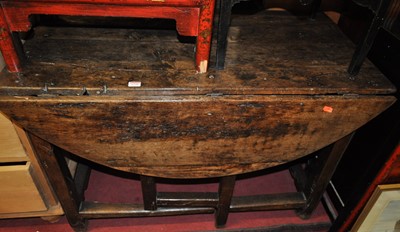 Lot 1250 - A rustic provincial joined oak dropflap...