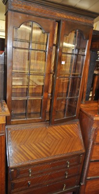 Lot 1254 - An Edwardian mahogany bureau bookcase, having...