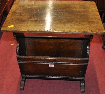 Lot 1273 - A contemporary oak magazine table, having chip...