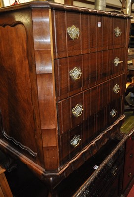 Lot 1283 - A German figured walnut shaped chest of four...