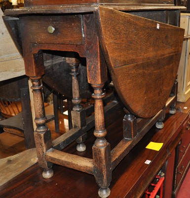 Lot 1292 - An antique joined oak dropleaf dining table,...