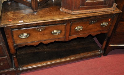 Lot 1300 - An antique joined oak and elm dresser base,...