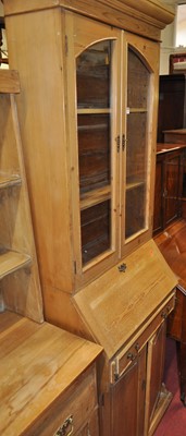 Lot 1305 - A pine narrow bureau bookcase, having twin...