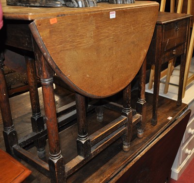 Lot 1310 - A 1920s oak gateleg occasional table; together...