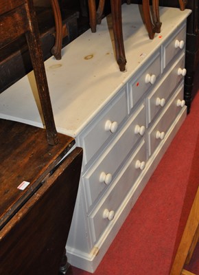 Lot 1314 - A modern pine white painted low chest, fitted...