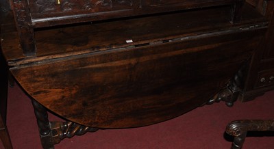 Lot 1320 - A large joined oak dropleaf dining table,...