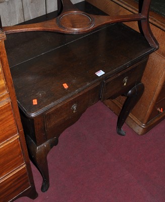 Lot 1335 - A 19th century oak two drawer lowboy, raised...