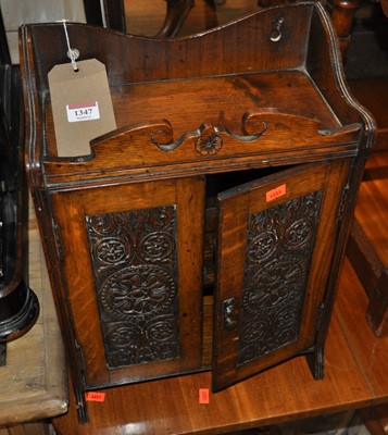 Lot 1347 - An early 20th century floral relief carved oak...