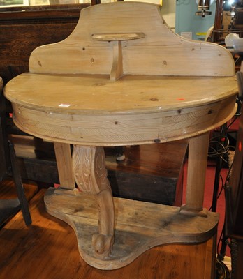 Lot 1353 - A Victorian limed pine demi-lune ledgeback...