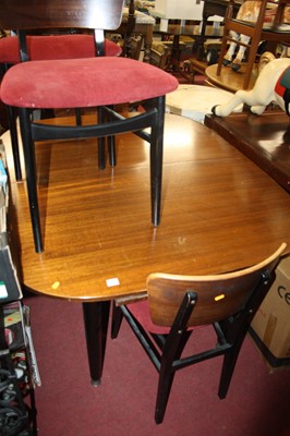 Lot 1402 - A 1970s teak and ebonised dining suite,...