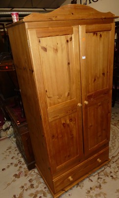 Lot 1409 - A modern pine double door wardrobe, with...