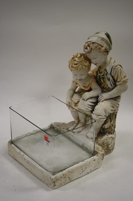 Lot 716 - A modern plaster figurine with standing glass...