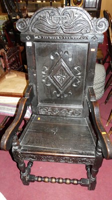 Lot 1423 - An antique ebonised and joined oak panelled...