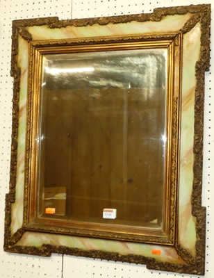 Lot 1136 - A floral gilt and onyx effect framed bevelled...