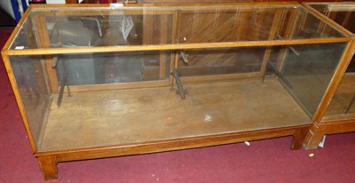 Lot 1120 - A mid-20th century blond oak long shop display...