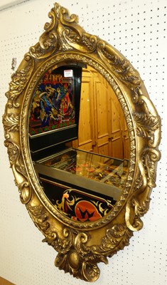 Lot 1124 - A contemporary floral gilt framed oval...