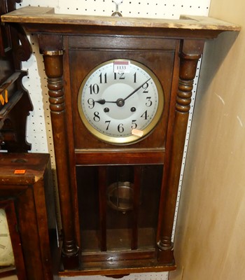 Lot 1133 - A 1930s walnut drop trunk wall clock, with...