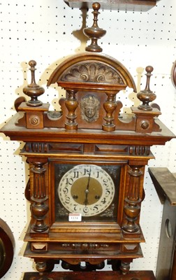 Lot 1134 - A late Victorian walnut wall clock, housed in...