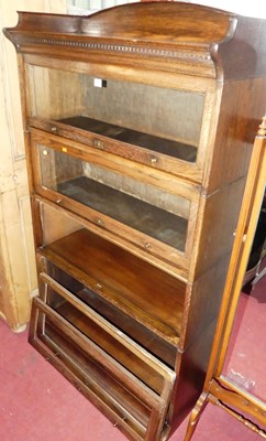 Lot 1152 - A 1930s oak four tier stacking bookcase by...