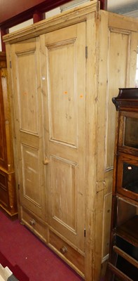 Lot 1153 - A reclaimed pine double door wardrobe, having...