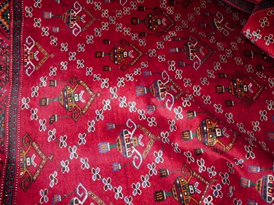 Lot 1162 - A Persian woollen red ground tribal "Kurd" rug,...