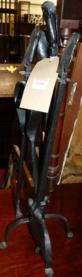 Lot 1180 - A set of three black painted wrought iron fire...