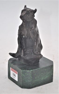 Lot 186 - A bronzed model of a bear, mounted upon a faux...