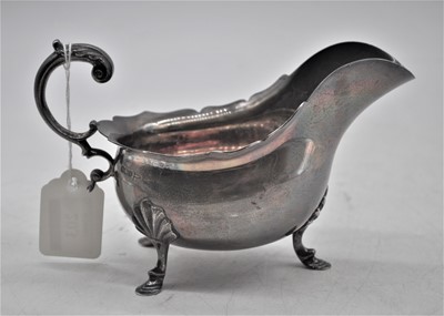 Lot 203 - An Edward VII silver sauceboat of helmet shape,...