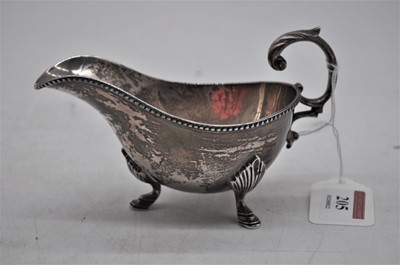 Lot 205 - An Edward VII silver sauceboat of helmet shape,...